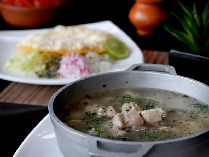 Bowl of Mexican soup with radish and lime